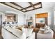 Comfortable living room with coffered ceilings, fireplace, built-in cabinets and open floor plan to kitchen at 27485 E Nova Pl, Aurora, CO 80016