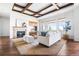 Spacious living room with a fireplace, coffered ceiling, and an abundance of natural light at 27485 E Nova Pl, Aurora, CO 80016