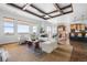 Open-concept living space featuring large windows and a coffered ceiling at 27485 E Nova Pl, Aurora, CO 80016