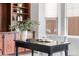Office interior with built-in shelving, desk, neutral walls and bright window views at 27485 E Nova Pl, Aurora, CO 80016
