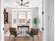 Bright home office featuring built-in bookshelves, bay window, and neutral decor at 27485 E Nova Pl, Aurora, CO 80016