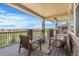Covered porch area with patio furniture and view of the landscape at 27485 E Nova Pl, Aurora, CO 80016
