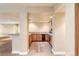 Basement wet bar with wood cabinets, granite countertops, wine fridge, and stainless steel appliances at 27485 E Nova Pl, Aurora, CO 80016