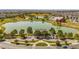 Community clubhouse with lake, scenic walking paths, lush landscaping and a large parking area at 10560 Waco St, Commerce City, CO 80022
