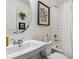 Bathroom featuring shower, vanity, round mirror, and modern fixtures at 10560 Waco St, Commerce City, CO 80022