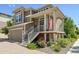 Two-story home with charming front porch, well-maintained landscaping, and attached garage at 10560 Waco St, Commerce City, CO 80022