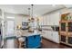 Modern kitchen featuring stainless steel appliances, granite countertops, and a stylish blue island at 10560 Waco St, Commerce City, CO 80022