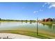 Scenic view of the lake and neighborhood clubhouse, a serene landscape, and blue skies at 10560 Waco St, Commerce City, CO 80022