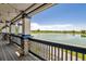 Covered patio offers a scenic view of the lake, with comfortable seating and stylish lighting at 10560 Waco St, Commerce City, CO 80022
