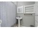 Bathroom featuring pedestal sink, storage, and shower with decorative curtain at 150 S Garfield St, Denver, CO 80209