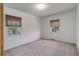 Spacious bedroom with soft carpeting, dual windows, and neutral colors at 150 S Garfield St, Denver, CO 80209