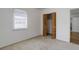 Bedroom with neutral carpet, light-filled window, and closet at 150 S Garfield St, Denver, CO 80209