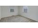 Bright, spacious bedroom featuring soft carpet, two large windows, and plenty of natural light at 150 S Garfield St, Denver, CO 80209