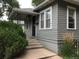 Charming home featuring gray siding, a cozy front porch, and manicured greenery at 150 S Garfield St, Denver, CO 80209