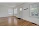 Bright living room featuring hardwood floors, fresh paint, and ample natural light at 150 S Garfield St, Denver, CO 80209