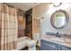 Bathroom featuring a modern single sink vanity, toilet, and a tiled shower and tub at 1740 Territory Cir, Parker, CO 80138