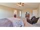 Large bedroom with dresser, ceiling fan, and entry door at 1740 Territory Cir, Parker, CO 80138
