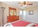 Inviting bedroom with ceiling fan, wooden dresser and soft, warm lighting at 1740 Territory Cir, Parker, CO 80138