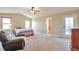 Spacious bedroom with a recliner, ceiling fan, and doorway to bathroom at 1740 Territory Cir, Parker, CO 80138