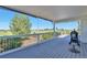 Covered deck featuring wood flooring, a built-in grill, and expansive views of the surrounding landscape at 1740 Territory Cir, Parker, CO 80138