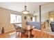 Dining room with wood floors and chandelier, featuring a view into the entryway at 1740 Territory Cir, Parker, CO 80138