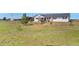 Ranch home featuring a covered front porch, nestled within a large green grassy yard and wooden fence at 1740 Territory Cir, Parker, CO 80138