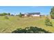 Residential home with an expansive front lawn, fenced yard, and mature trees under a blue sky at 1740 Territory Cir, Parker, CO 80138