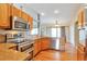 Kitchen with stainless steel appliances, light wood cabinetry, and hardwood floors at 1740 Territory Cir, Parker, CO 80138