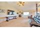 Spacious living room with a fireplace, a comfortable seating area, and carpeted flooring at 1740 Territory Cir, Parker, CO 80138