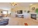 Bright living room with fireplace, carpet, and a large window for natural light at 1740 Territory Cir, Parker, CO 80138