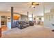 Open-concept living room with carpet, featuring views of the kitchen and entryway at 1740 Territory Cir, Parker, CO 80138