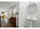 Clean and modern powder room featuring a pedestal sink and stylish fixtures at 7868 Downing St, Denver, CO 80229