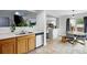 Modern kitchen with stainless steel appliances, white countertops, and open access to the dining area at 7868 Downing St, Denver, CO 80229