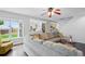 Open-concept living room featuring a large window, fan and comfortable gray sectional couch at 7868 Downing St, Denver, CO 80229