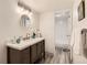 Well-lit bathroom featuring a modern vanity, a round mirror, and a shower with new subway tile at 9700 E Iliff Ave # C20, Denver, CO 80231