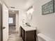 Well lit bathroom with updated vanity, decor and access to the primary bedroom at 9700 E Iliff Ave # C20, Denver, CO 80231