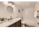 Charming bathroom with round mirror, modern fixtures, and white tiled shower at 9700 E Iliff Ave # C20, Denver, CO 80231