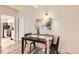 Cozy dining area with wooden table, modern chairs, and open doorway to the kitchen at 9700 E Iliff Ave # C20, Denver, CO 80231