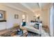 Bright living room with white sofa, modern rug, and open doorway to the kitchen at 9700 E Iliff Ave # C20, Denver, CO 80231