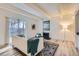 Bright living room with white sofa, decorative rug, fireplace, and a sliding glass door at 9700 E Iliff Ave # C20, Denver, CO 80231