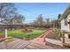 Landscaped backyard featuring a well-maintained lawn, brick pathway, and wooden deck at 1011 Uvalda St, Aurora, CO 80011