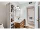 Bright bathroom featuring a single sink vanity, ample storage, and updated lighting fixtures at 1011 Uvalda St, Aurora, CO 80011