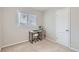 Well-lit bedroom space, carpeted, featuring a bright window and functional layout at 1011 Uvalda St, Aurora, CO 80011