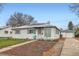 Charming single-story home featuring a well-maintained yard and detached garage at 1011 Uvalda St, Aurora, CO 80011