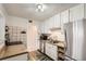 Efficient kitchen featuring stainless steel appliances, white cabinetry, and modern countertops at 1011 Uvalda St, Aurora, CO 80011