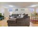 Spacious finished basement with a large sectional and a decorative sports sign at 12520 W Virginia Ave, Lakewood, CO 80228