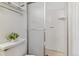 Clean bathroom featuring a shower with glass doors and white tiled walls at 12520 W Virginia Ave, Lakewood, CO 80228