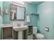 Stylish powder room with a pedestal sink, modern fixtures, and decorative accents at 12520 W Virginia Ave, Lakewood, CO 80228