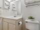 Cozy bathroom with a neutral color palette, vanity storage, and toilet at 12520 W Virginia Ave, Lakewood, CO 80228