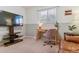 Well-lit bedroom with a comfortable seating area and a mounted television at 12520 W Virginia Ave, Lakewood, CO 80228